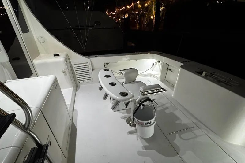 Slide: The Image of 2002 Cavileer 48 Flybridge Sportfish cockpit with fishing chair and equipment at night. - 24