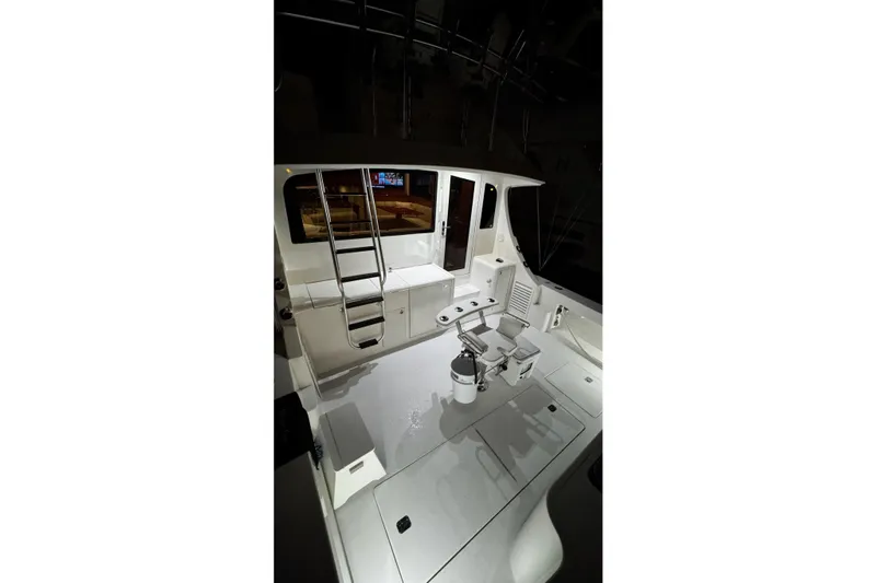 Slide: The Image of 2002 Cavileer 48 Flybridge Sportfish boat interior with ladder and seating area. - 25