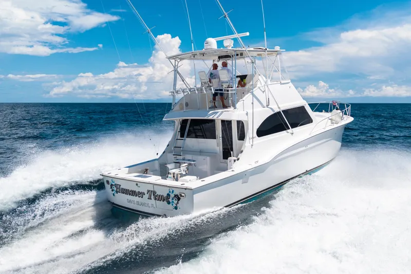 Slide: The Image of 2002 Cavileer 48 Flybridge Sportfish cruising on open ocean under clear blue sky. - 3