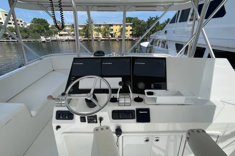 Slide: The Image of Helm of 2002 Cavileer 48 Flybridge Sportfish with navigation equipment and steering wheel. - 41
