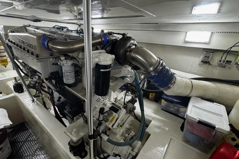Slide: The Image of Engine room of 2002 Cavileer 48 Flybridge Sportfish, showcasing a powerful marine engine. - 42