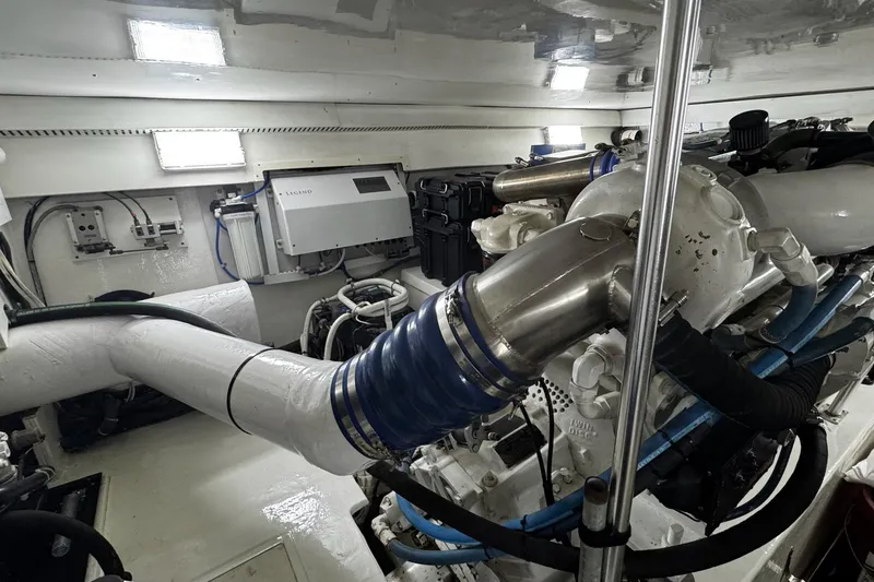 Slide: The Image of Engine room of 2002 Cavileer 48 Flybridge Sportfish with visible machinery and components. - 43