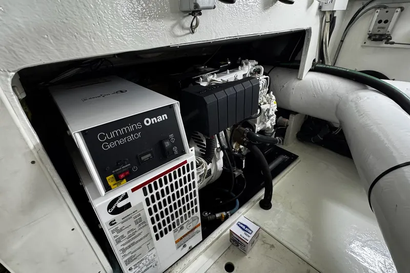 Slide: The Image of Cummins Onan generator in 2002 Cavileer 48 Flybridge Sportfish engine room. - 44