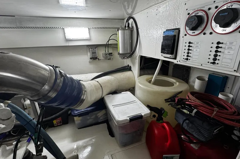 Slide: The Image of Engine room of 2002 Cavileer 48 Flybridge Sportfish with control panels and equipment. - 46