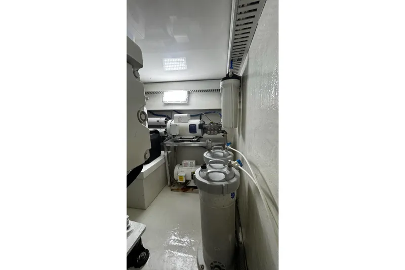 Slide: The Image of Engine room of 2002 Cavileer 48 Flybridge Sportfish with filtration system and equipment. - 47