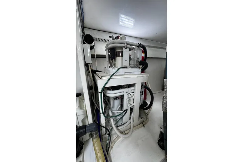 Slide: The Image of Engine room of 2002 Cavileer 48 Flybridge Sportfish with visible machinery and wiring. - 48