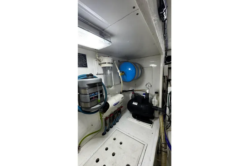 Slide: The Image of Engine room of 2002 Cavileer 48 Flybridge Sportfish with mechanical equipment and piping. - 49