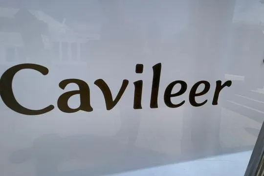 Slide: The Image of Cavileer 48 Flybridge Sportfish 2002 logo on a reflective surface. - 51