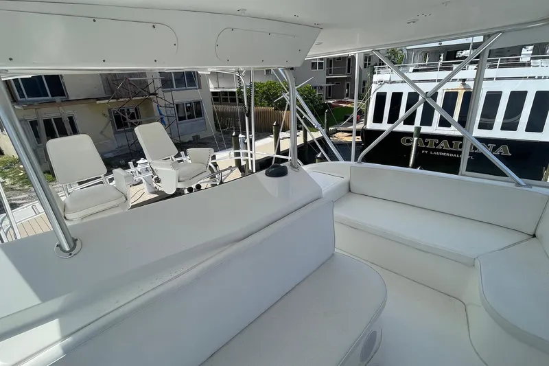 Slide: The Image of 2002 Cavileer 48 Flybridge Sportfish interior with white seating and helm chairs. - 53