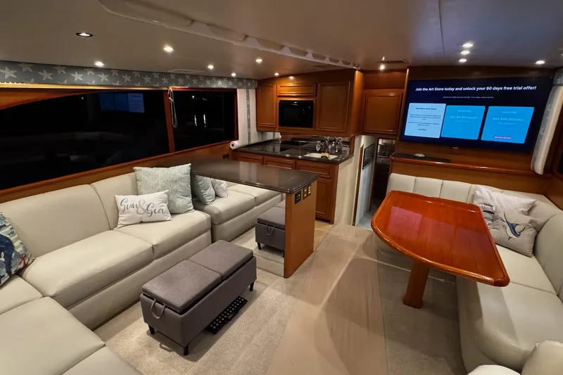 Slide: The Image of Luxurious interior of 2002 Cavileer 48 Flybridge Sportfish yacht with elegant seating and dining area. - 6