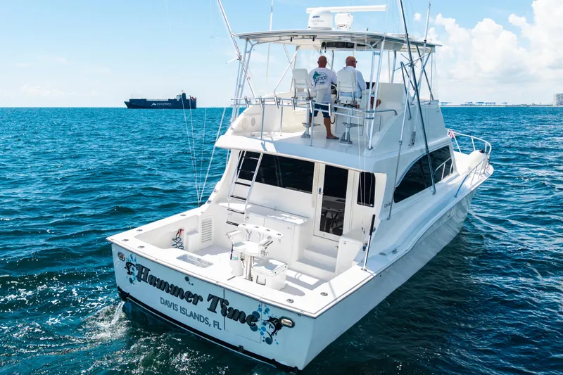 Slide: The Image of 2002 Cavileer 48 Flybridge Sportfish yacht cruising on open water. - 61