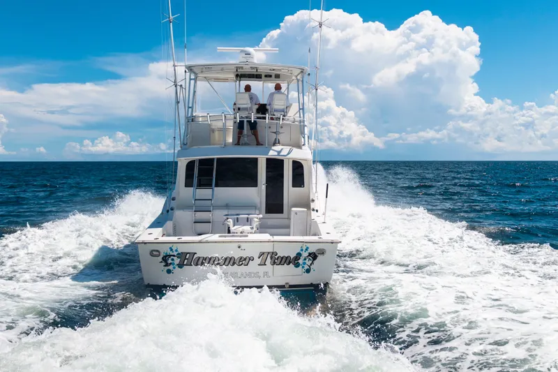 Slide: The Image of 2002 Cavileer 48 Flybridge Sportfish cruising on open ocean under blue sky. - 63