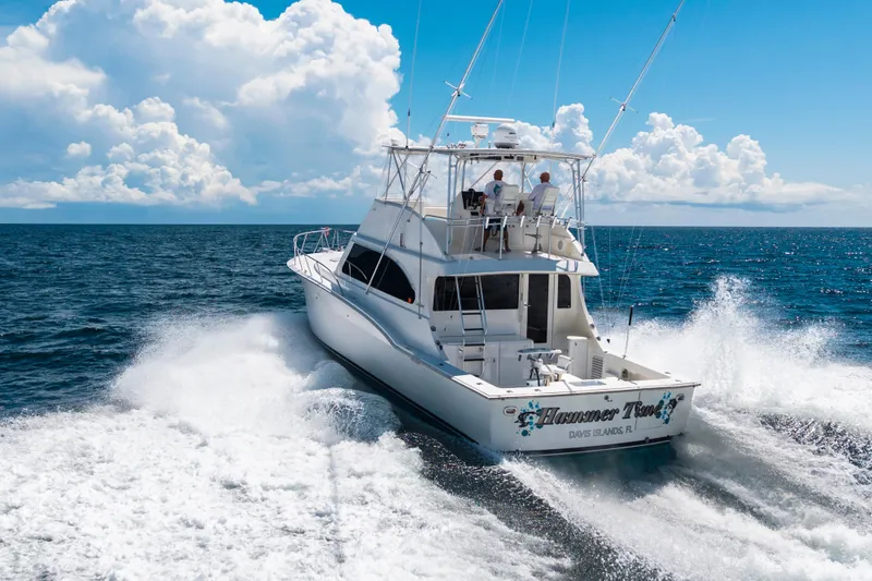Slide: The Image of 2002 Cavileer 48 Flybridge Sportfish cruising on open ocean under clear skies. - 65