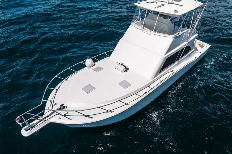 Slide: The Image of 2002 Cavileer 48 Flybridge Sportfish yacht cruising on open water. - 70