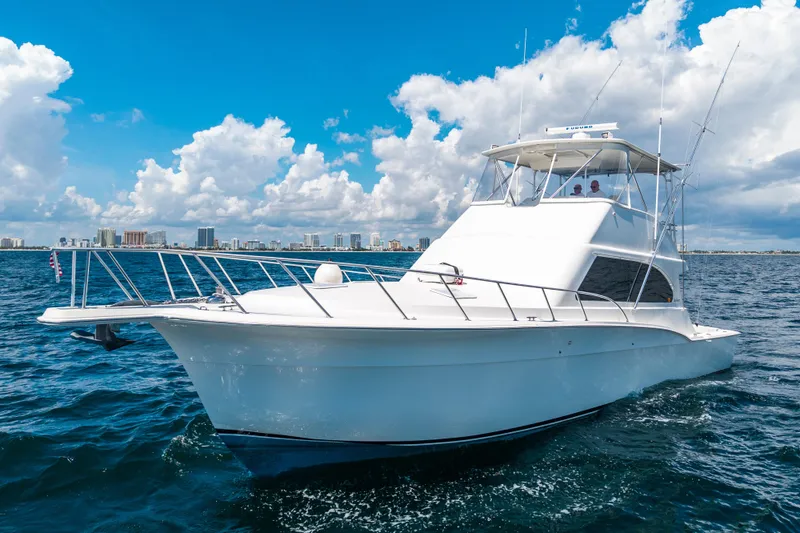 Slide: The Image of 2002 Cavileer 48 Flybridge Sportfish yacht cruising on open water under blue skies. - 71