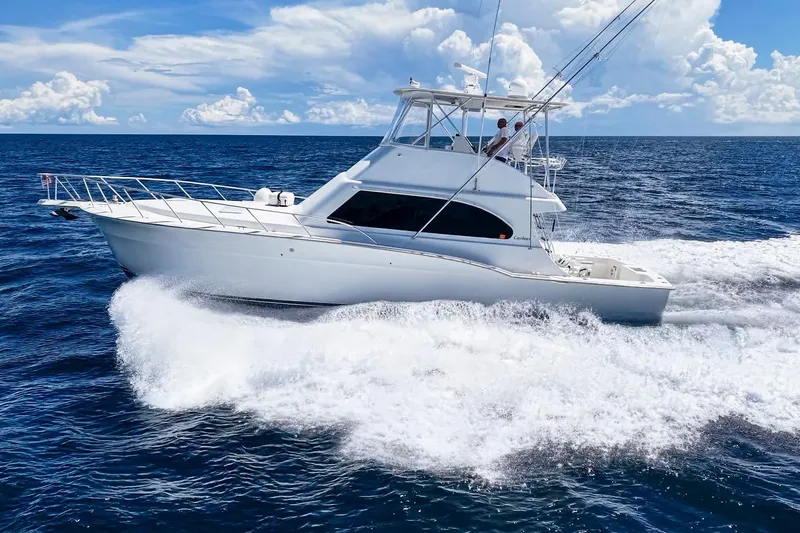 Slide: The Image of 2002 Cavileer 48 Flybridge Sportfish cruising on open ocean under clear skies. - 75