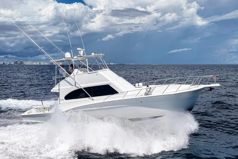 Slide: The Image of 2002 Cavileer 48 Flybridge Sportfish cruising on open ocean under cloudy sky. - 76