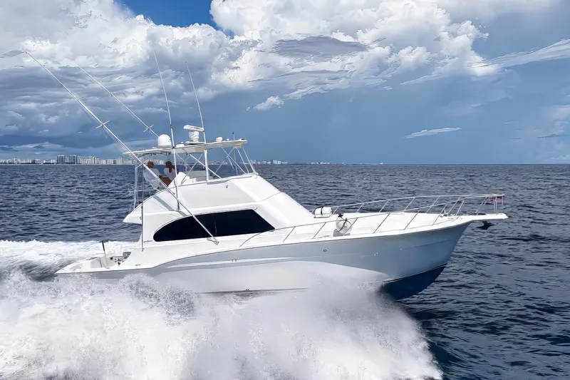 Slide: The Image of 2002 Cavileer 48 Flybridge Sportfish cruising on open ocean under cloudy sky. - 77