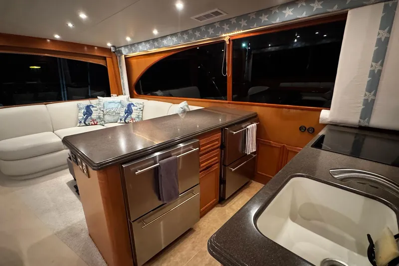 Slide: The Image of Luxurious interior of 2002 Cavileer 48 Flybridge Sportfish yacht with modern kitchen and seating area. - 9