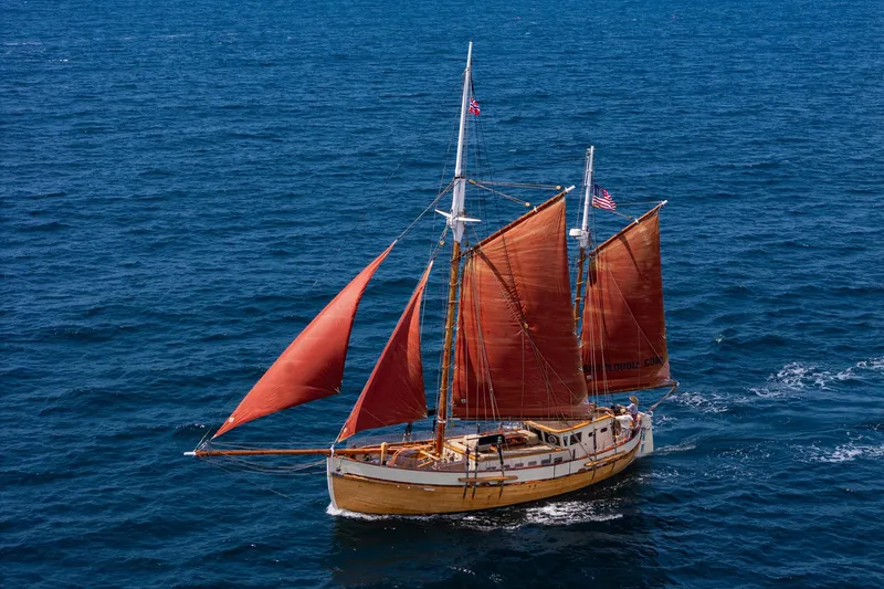 The Image of Vintage 1938 Norwegian Double Ended Ketch sailing on open sea with red sails. - 1