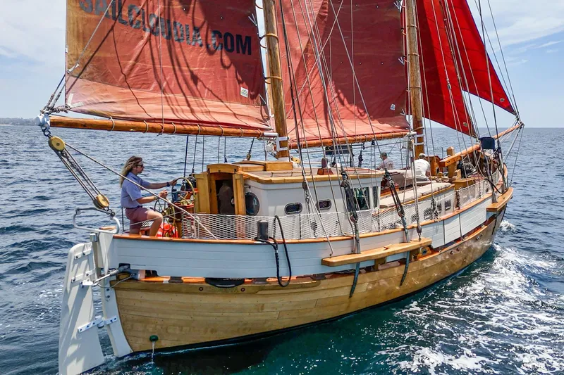 Slide: The Image of 1938 Norwegian Double Ended Ketch sailing on open sea with red sails. - 10