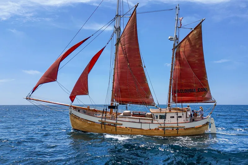 Slide: The Image of Vintage 1938 Norwegian Double Ended Ketch sailing on open sea with red sails. - 12