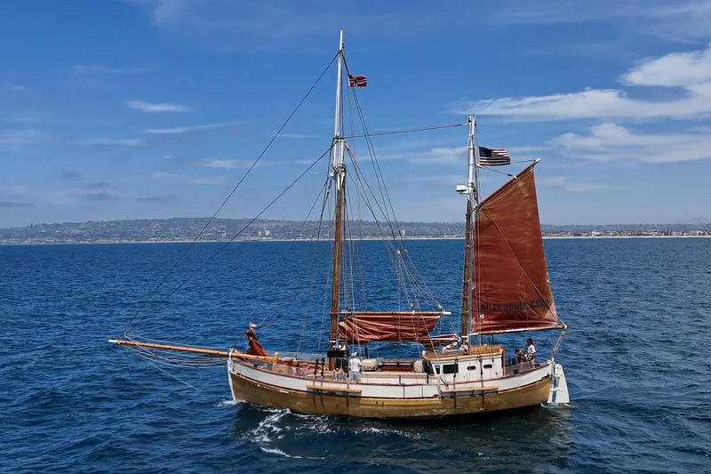 Slide: The Image of Vintage 1938 Norwegian Double Ended Ketch sailing on open sea under clear skies. - 15
