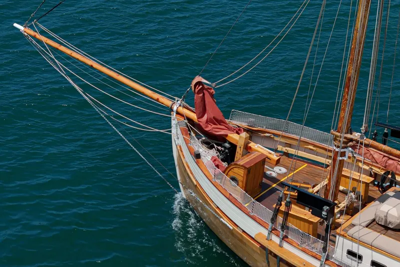 Slide: The Image of 1938 Norwegian Double Ended Ketch sailing on blue water, showcasing wooden craftsmanship. - 24