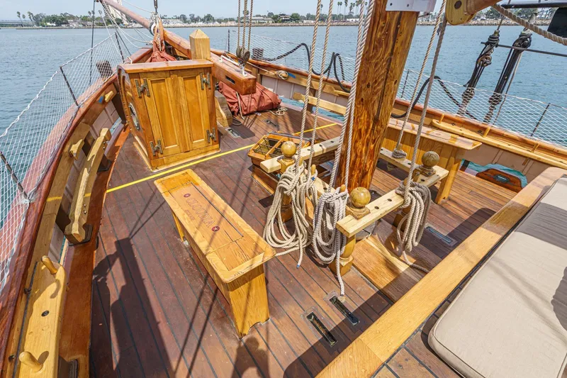 Slide: The Image of Wooden deck of 1938 Norwegian Double Ended Ketch with ropes and seating. - 29