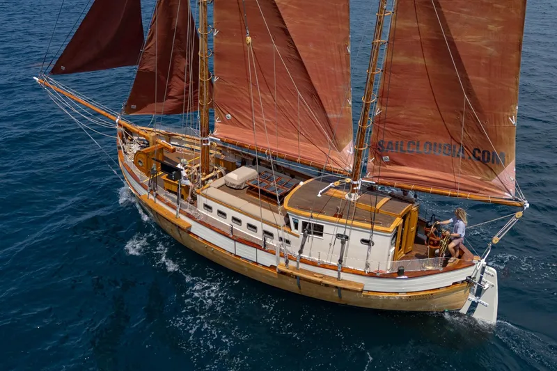 Slide: The Image of 1938 Norwegian Double Ended Ketch sailing on open sea with red sails. - 3