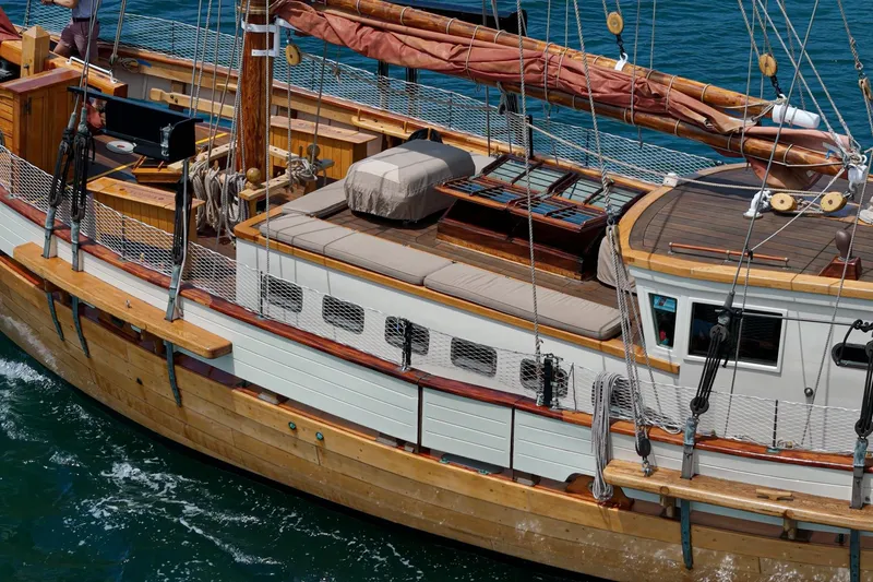 Slide: The Image of 1938 Norwegian Double Ended Ketch sailing on blue water, showcasing wooden deck and rigging. - 36