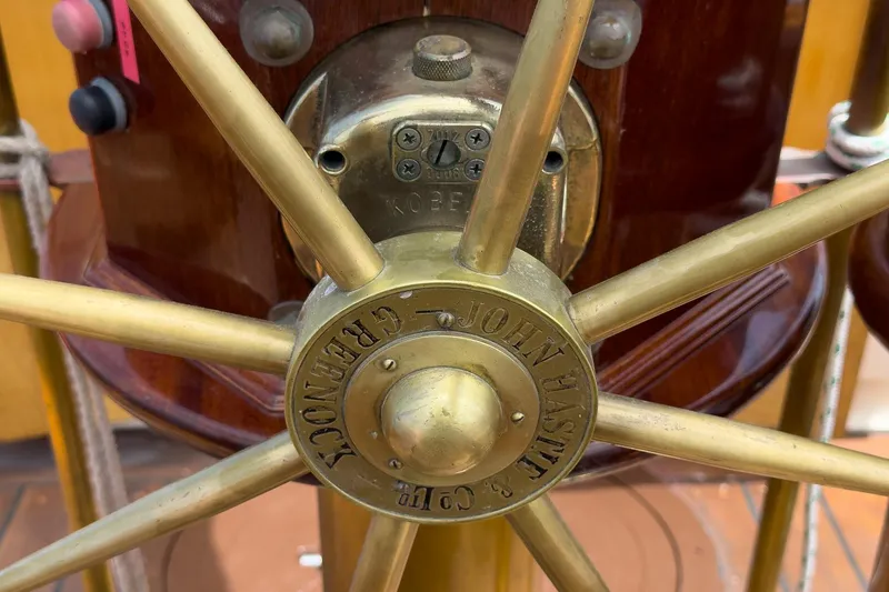 Slide: The Image of Close-up of a brass ship's wheel on a 1938 Norwegian Double Ended Ketch. - 48