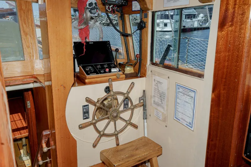 Slide: The Image of Interior of a 1938 Norwegian Double Ended Ketch with wooden helm and navigation equipment. - 62