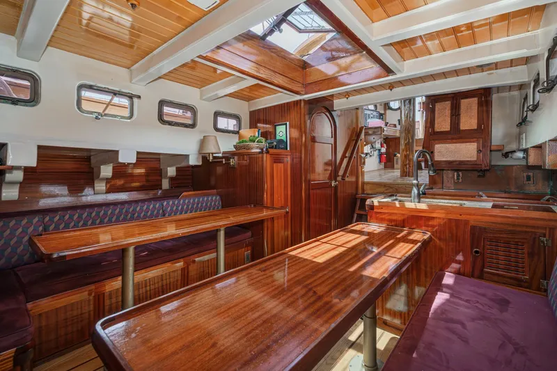 Slide: The Image of Interior of a 1938 Norwegian Double Ended Ketch with polished wood and cozy seating. - 69