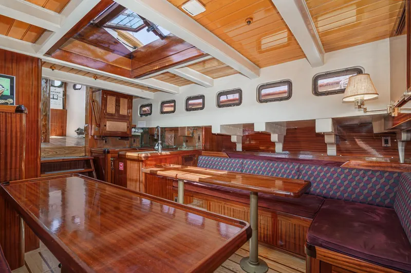 Slide: The Image of Interior of 1938 Norwegian Double Ended Ketch with polished wood and cozy seating. - 70