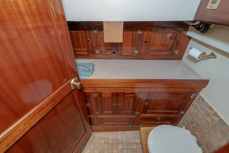 Slide: The Image of Wooden bathroom interior of 1938 Norwegian Double Ended Ketch with cabinets and toilet. - 71
