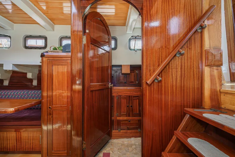 Slide: The Image of Interior of 1938 Norwegian Double Ended Ketch with polished wood and cozy seating area. - 74