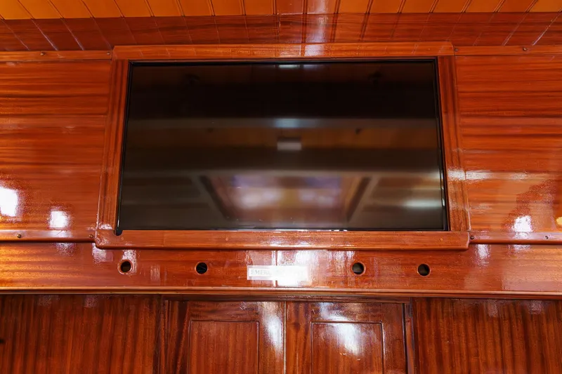 Slide: The Image of Polished wooden interior of 1938 Norwegian Double Ended Ketch with mounted screen. - 75