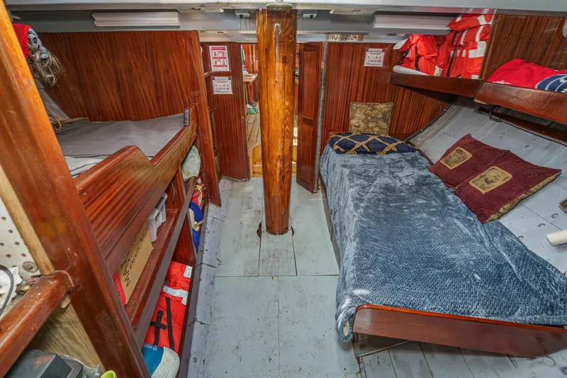 Slide: The Image of Interior of a 1938 Norwegian Double Ended Ketch with wooden bunks and nautical decor. - 78