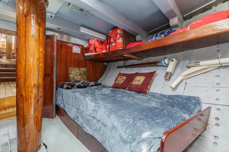 Slide: The Image of Cozy cabin interior of 1938 Norwegian Double Ended Ketch with wooden accents and nautical decor. - 79