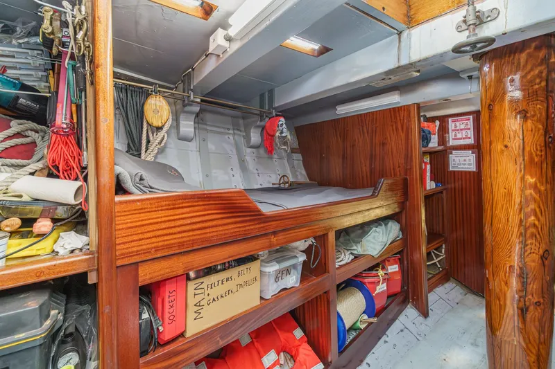 Slide: The Image of Interior of a 1938 Norwegian Double Ended Ketch with wooden bunk and storage. - 80