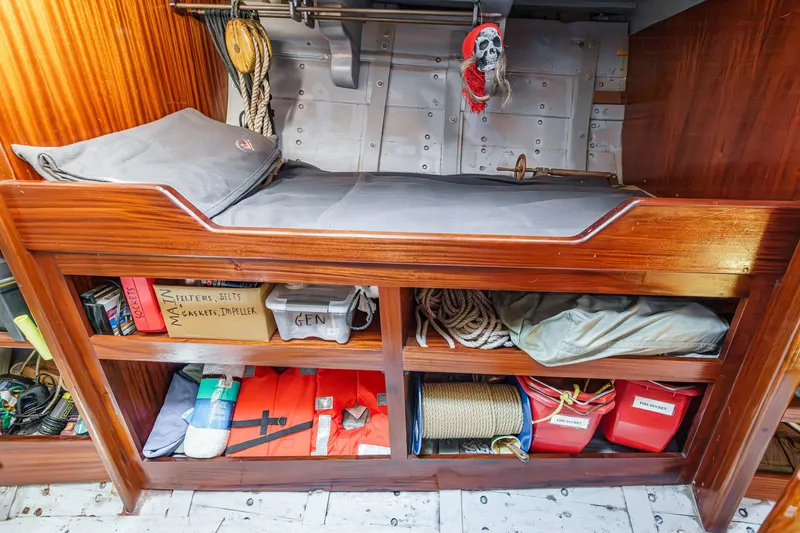 Slide: The Image of Cozy cabin interior of 1938 Norwegian Double Ended Ketch with storage and nautical decor. - 81
