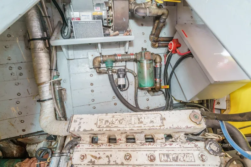 Slide: The Image of Engine room of a 1938 Norwegian Double Ended Ketch, showcasing mechanical components and piping. - 86