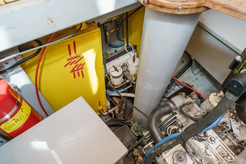 Slide: The Image of Engine room of a 1938 Norwegian Double Ended Ketch with visible components and fire extinguisher. - 88