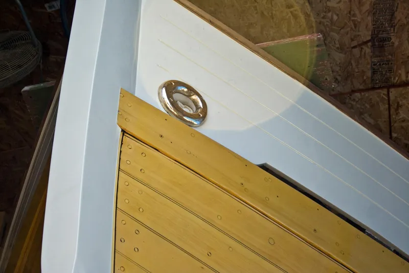 Slide: The Image of Close-up of 1938 Vintage Norwegian Double Ended Ketch deck with wooden planks and metal fixture. - 95