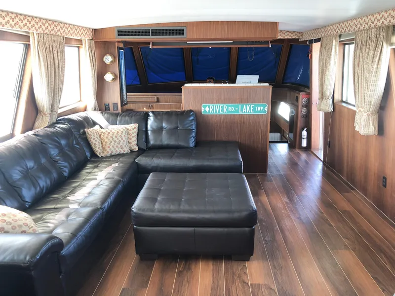 Slide: The Image of Luxurious 1985 Hatteras 56 Motor Yacht interior with leather seating and wood paneling. - 1