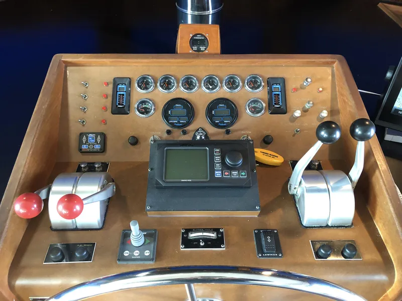Slide: The Image of Control panel of a 1985 Hatteras 56 Motor Yacht with gauges and levers. - 11