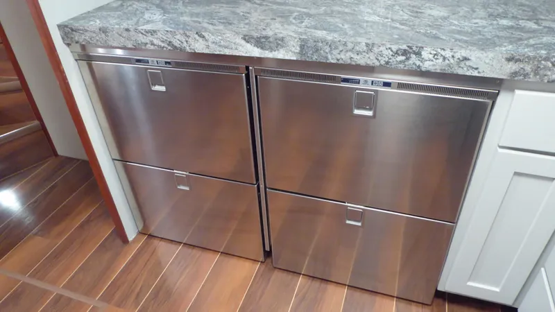 Slide: The Image of Stainless steel drawers in 1985 Hatteras 56 Motor Yacht kitchen with wood flooring. - 16