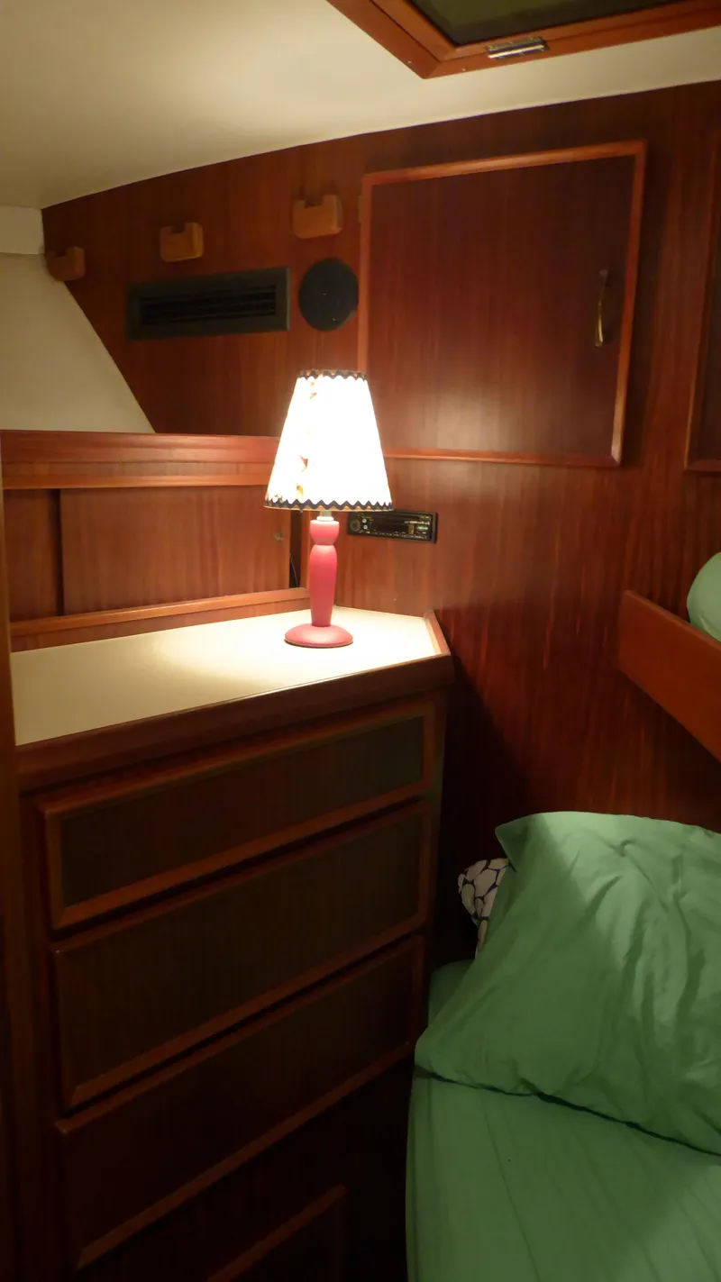 Slide: The Image of Cozy cabin interior of 1985 Hatteras 56 Motor Yacht with lamp and wooden furnishings. - 21