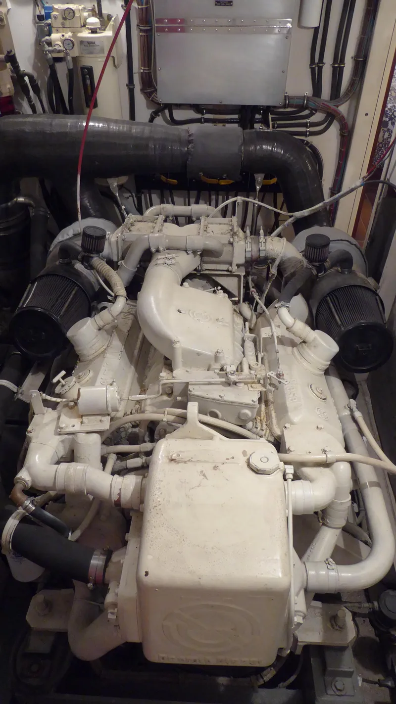 Slide: The Image of Engine room of 1985 Hatteras 56 Motor Yacht, showcasing detailed machinery. - 27
